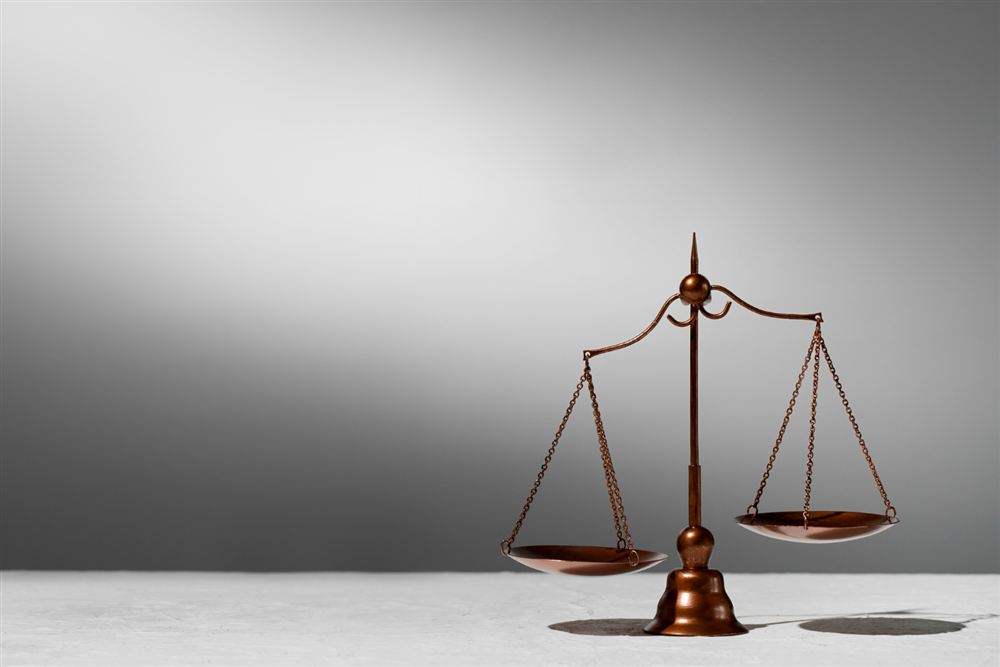 Scales of justice on a gray background