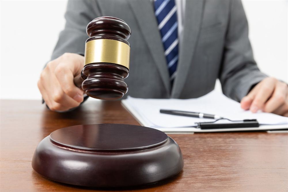 Gavel on a desk with papers