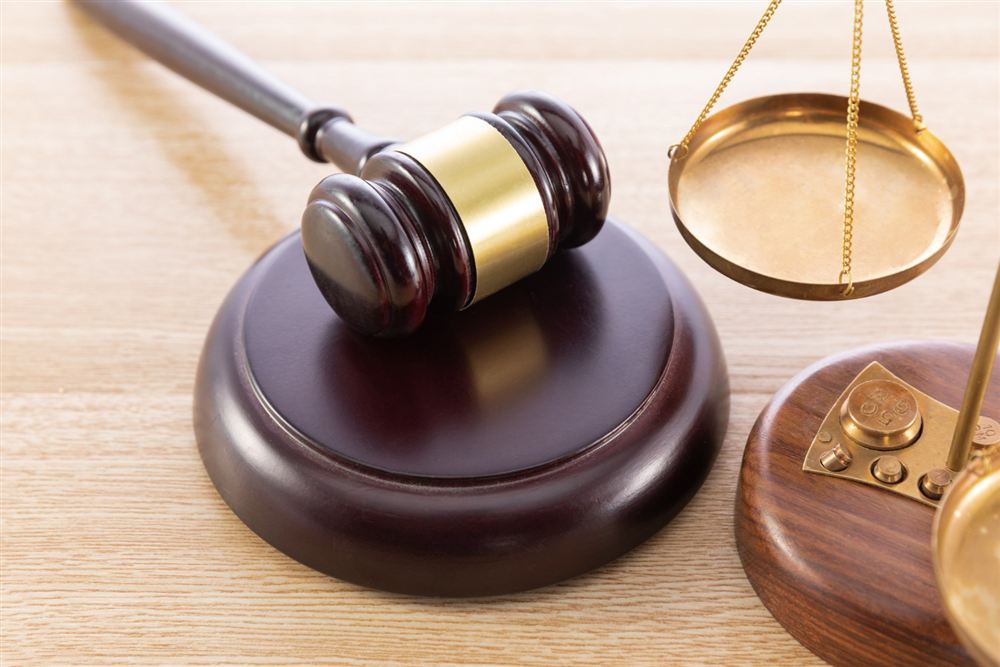 Gavel and brass scales on a wooden desk